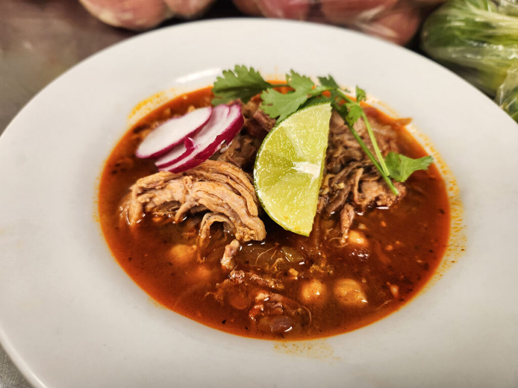 A bowl of delicious Pozole, a traditional Mexican soup made with hominy, meat, and flavorful spices.