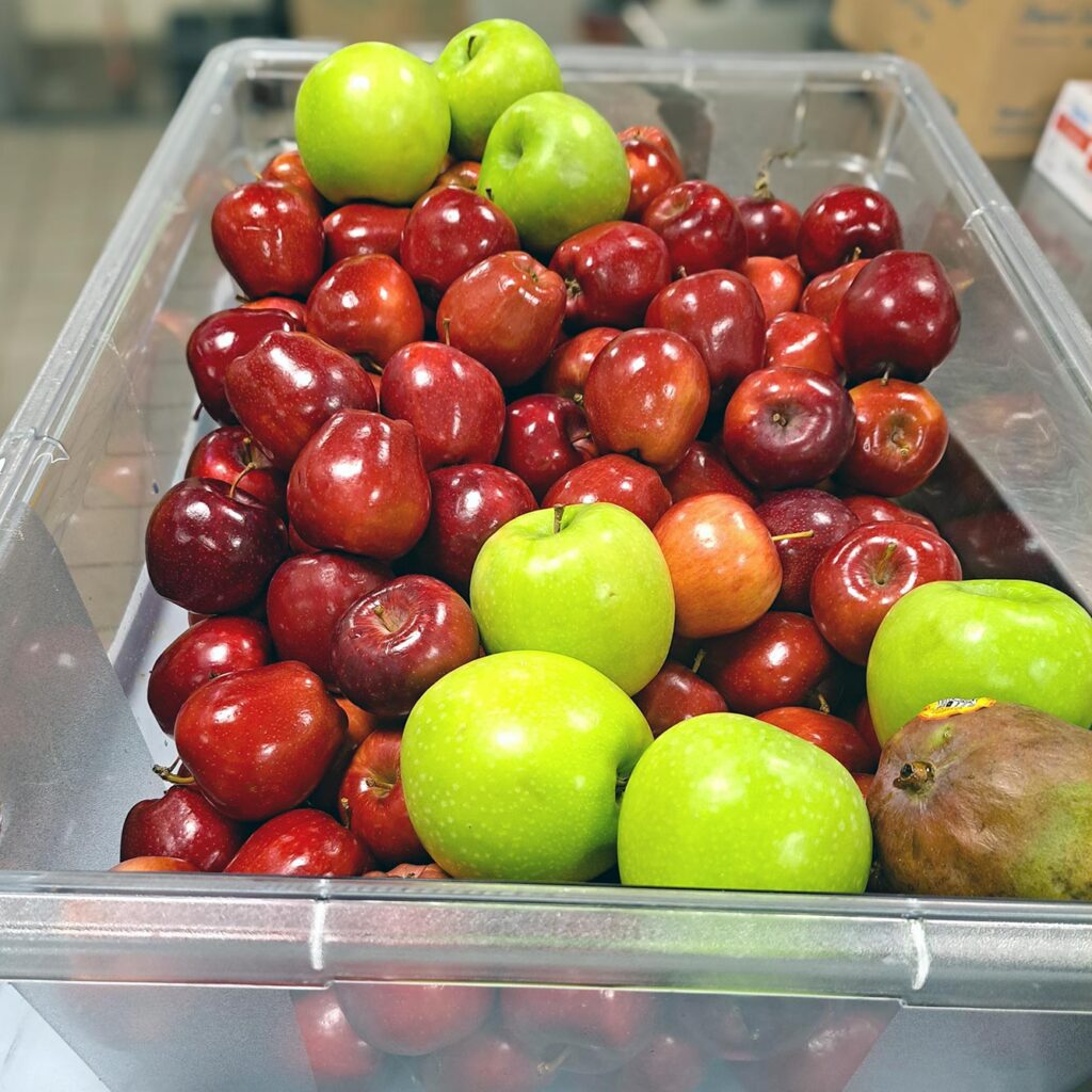 A large container of shiny red and green apples at The Boulevard Senior Living St. Peters.