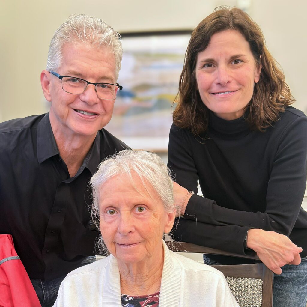 Loved ones and a senior resident smile at The Boulevard Senior Living of St. Peters.