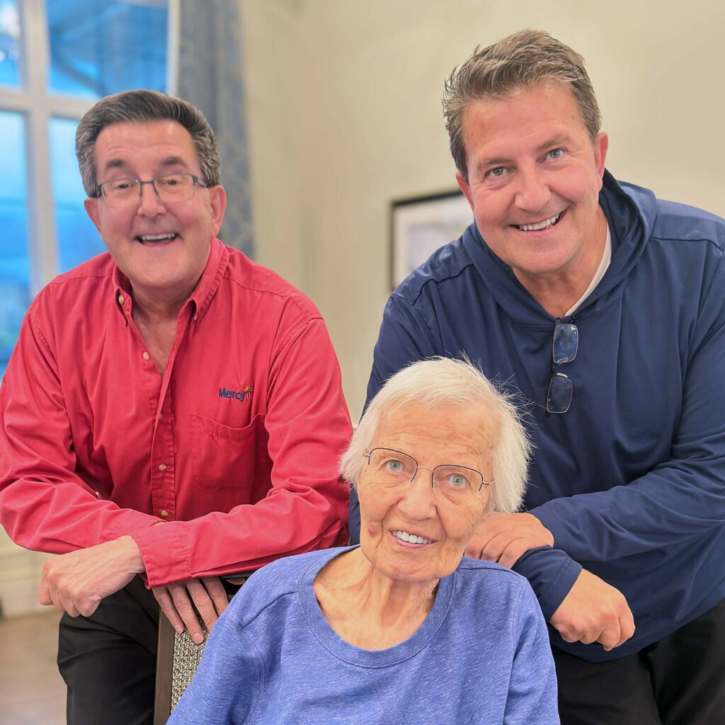 Two men and a senior woman smile, showcasing the importance of family engagement.