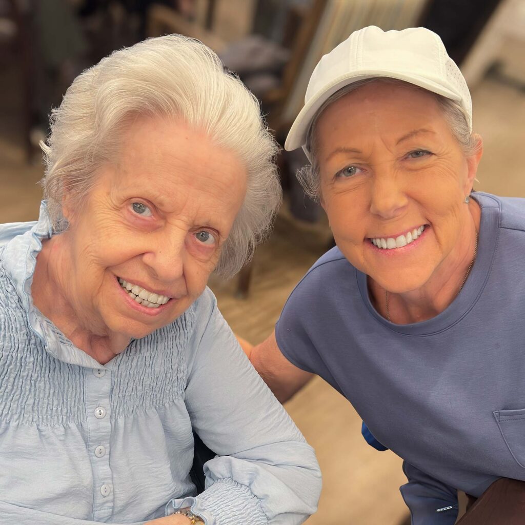 Two women smile during a joyful moment at The Boulevard Senior Living of St. Peters.