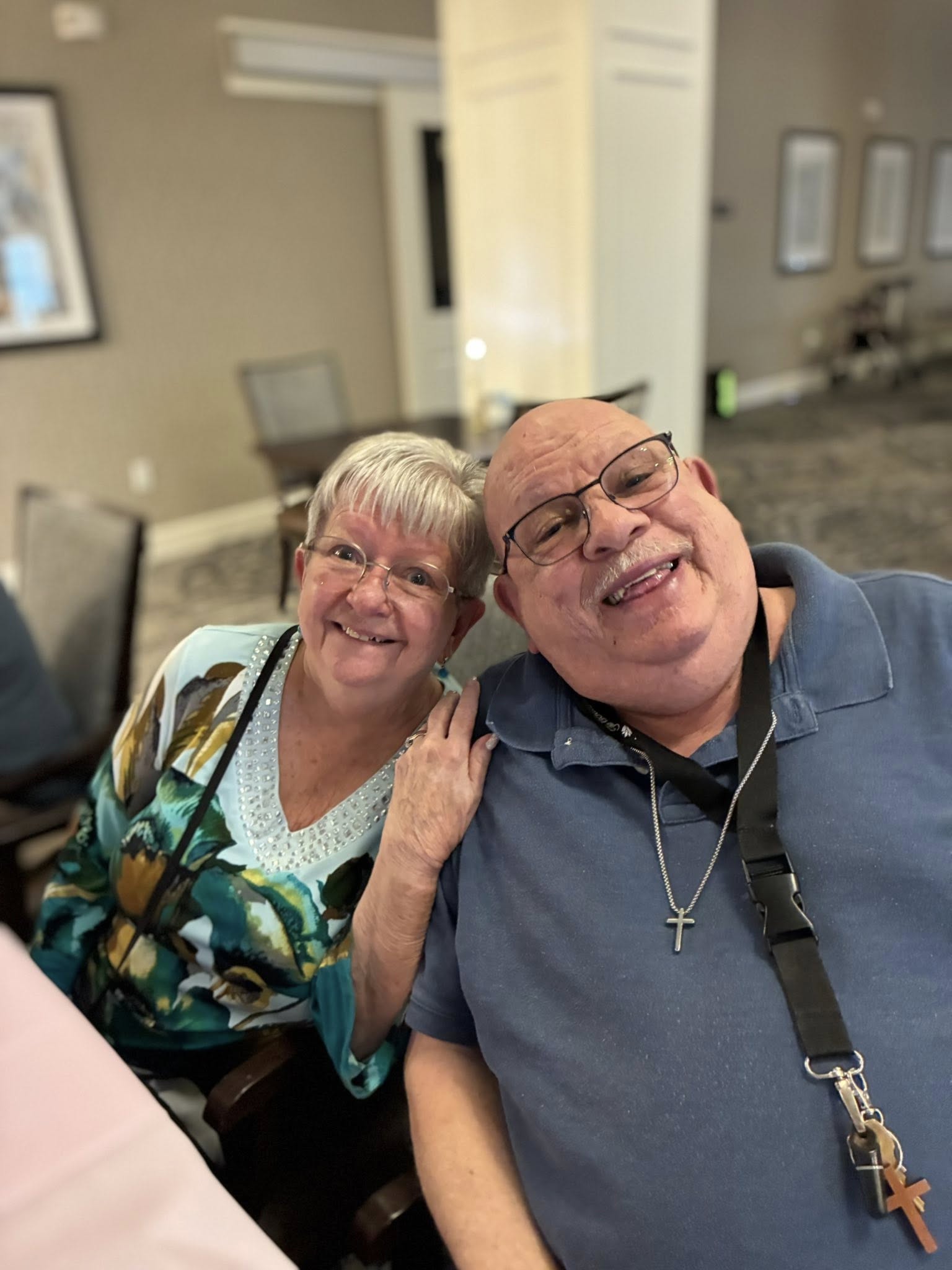 Two senior living residents smile and pose together at The Boulevard Senior Living of Saint Peters.
